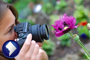 a female photographer photographing a flower close-up - with Washington, DC icon