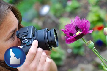 a female photographer photographing a flower close-up - with Idaho icon