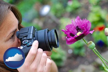 a female photographer photographing a flower close-up - with Kentucky icon
