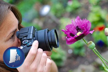 a female photographer photographing a flower close-up - with Rhode Island icon
