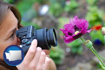 a female photographer photographing a flower close-up - with Washington icon