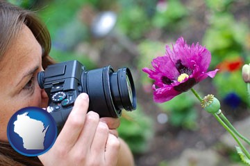 a female photographer photographing a flower close-up - with Wisconsin icon