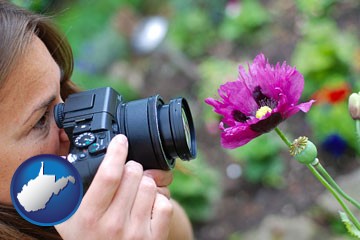 a female photographer photographing a flower close-up - with West Virginia icon