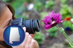 alabama map icon and a female photographer photographing a flower close-up