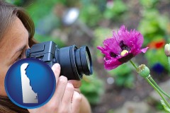 delaware map icon and a female photographer photographing a flower close-up