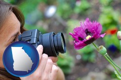 georgia map icon and a female photographer photographing a flower close-up
