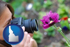 idaho map icon and a female photographer photographing a flower close-up