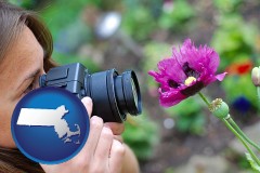 massachusetts map icon and a female photographer photographing a flower close-up
