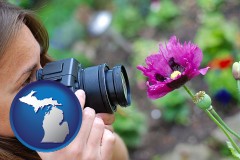 michigan map icon and a female photographer photographing a flower close-up