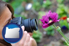oregon map icon and a female photographer photographing a flower close-up